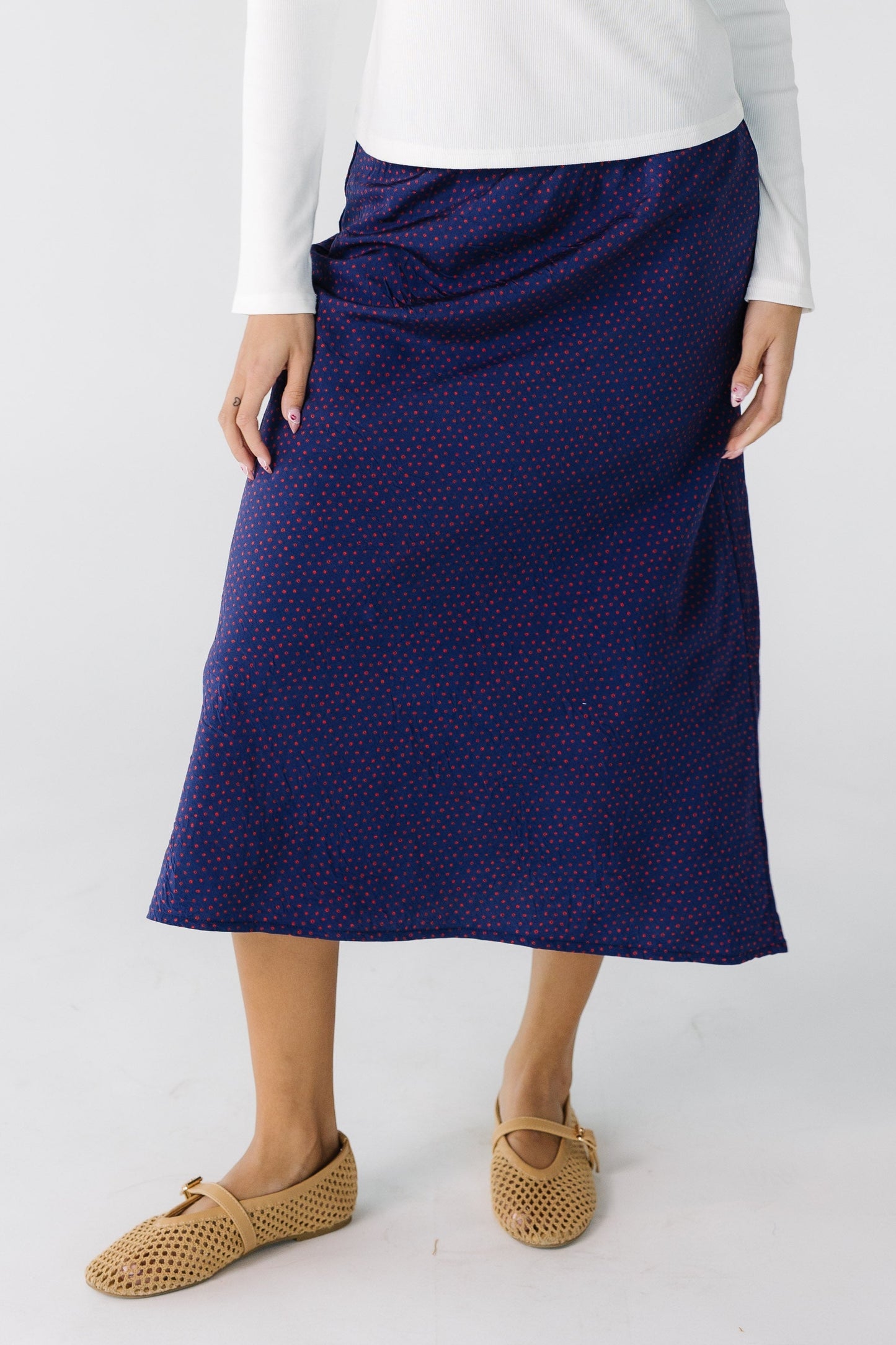 Teen girl wearing a  dark purple print  A-line skirt.