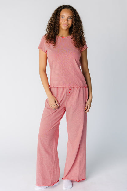 Woman wearing a modest 2 piece pajama set with short sleeves and long wide cut pant