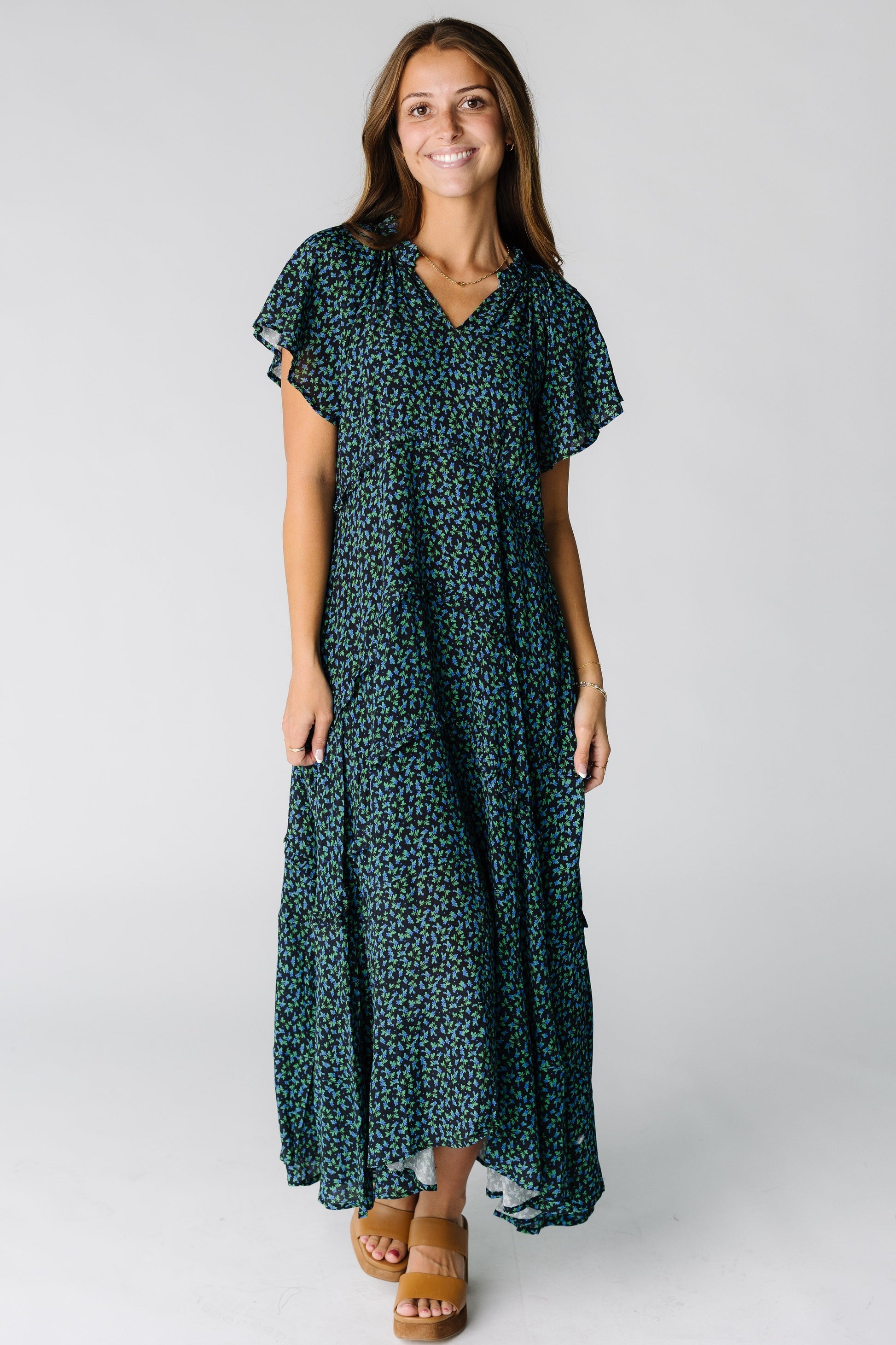 Woman wearing a modest midi-maxi dress with multiple tiers