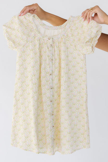Modest button down girls dress in cream floral with short sleeves.