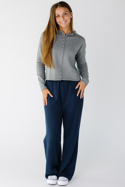 Woman wearing a pair of navy waffle knit pants with a wide cut leg