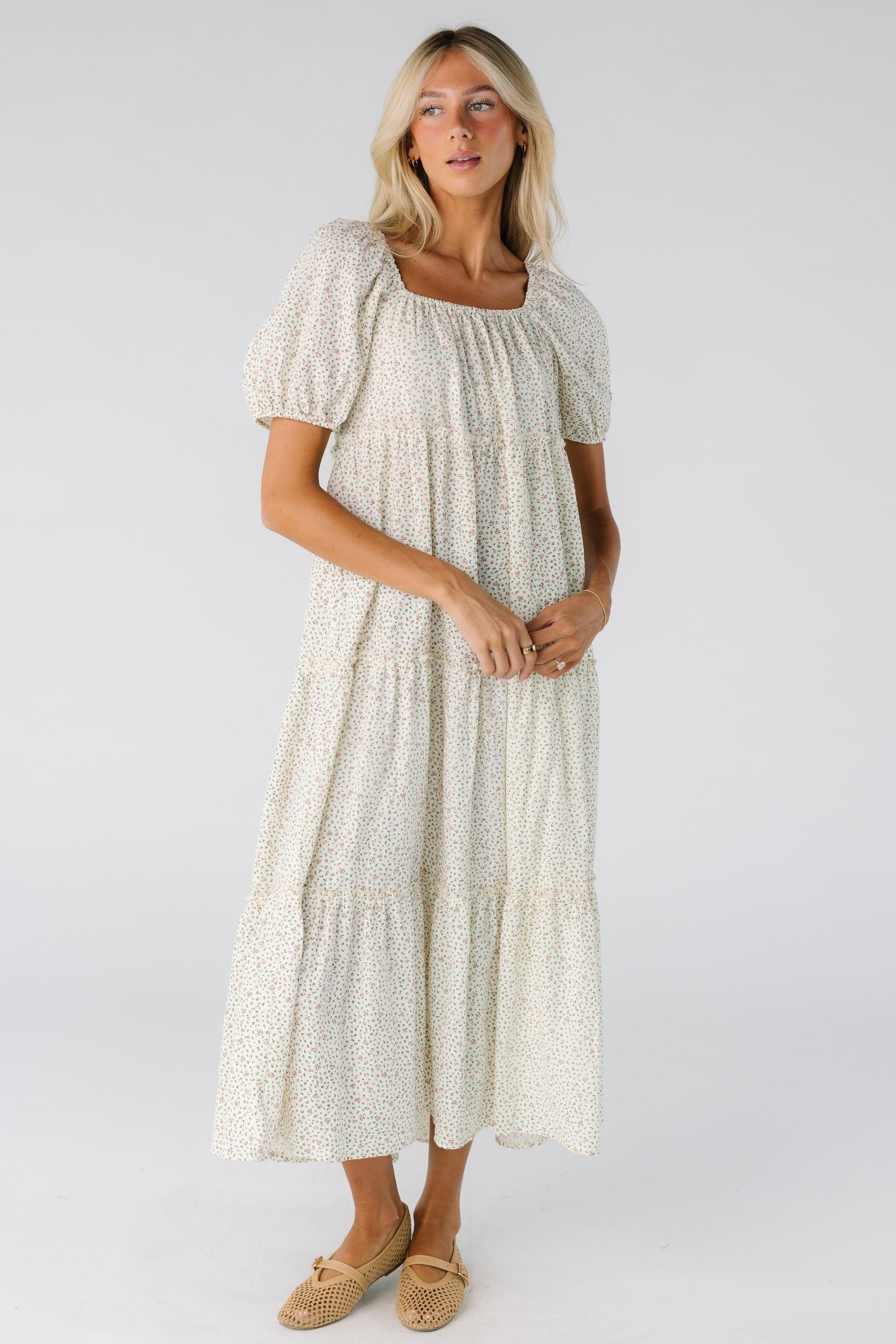 Woman wearing a cream floral midi dress 