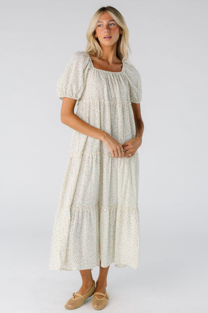Woman wearing a cream floral midi dress 