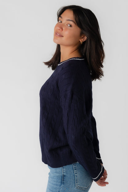 Side view of navy crew neck cable sweater