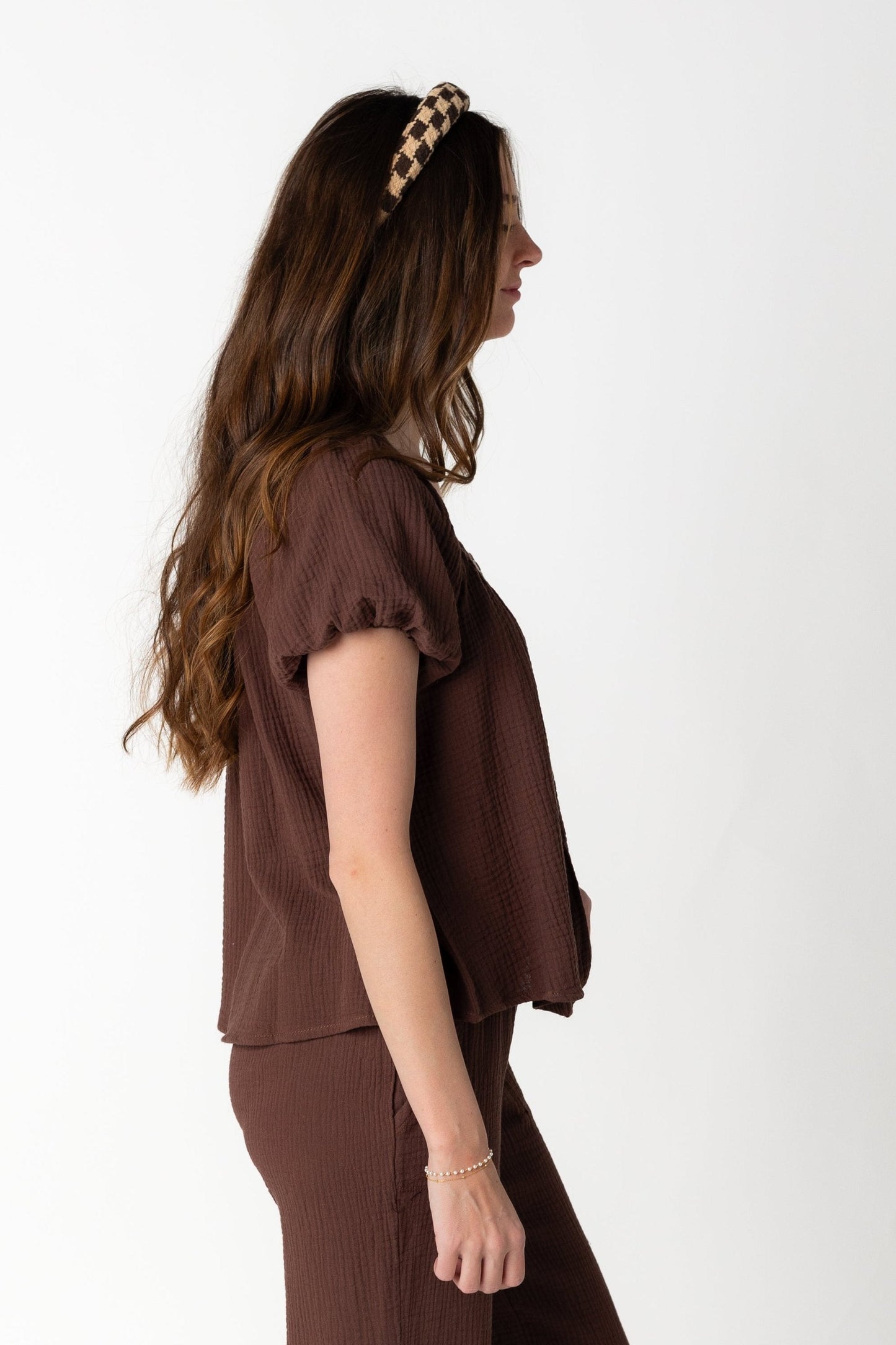 Side view of brown puff sleeve top