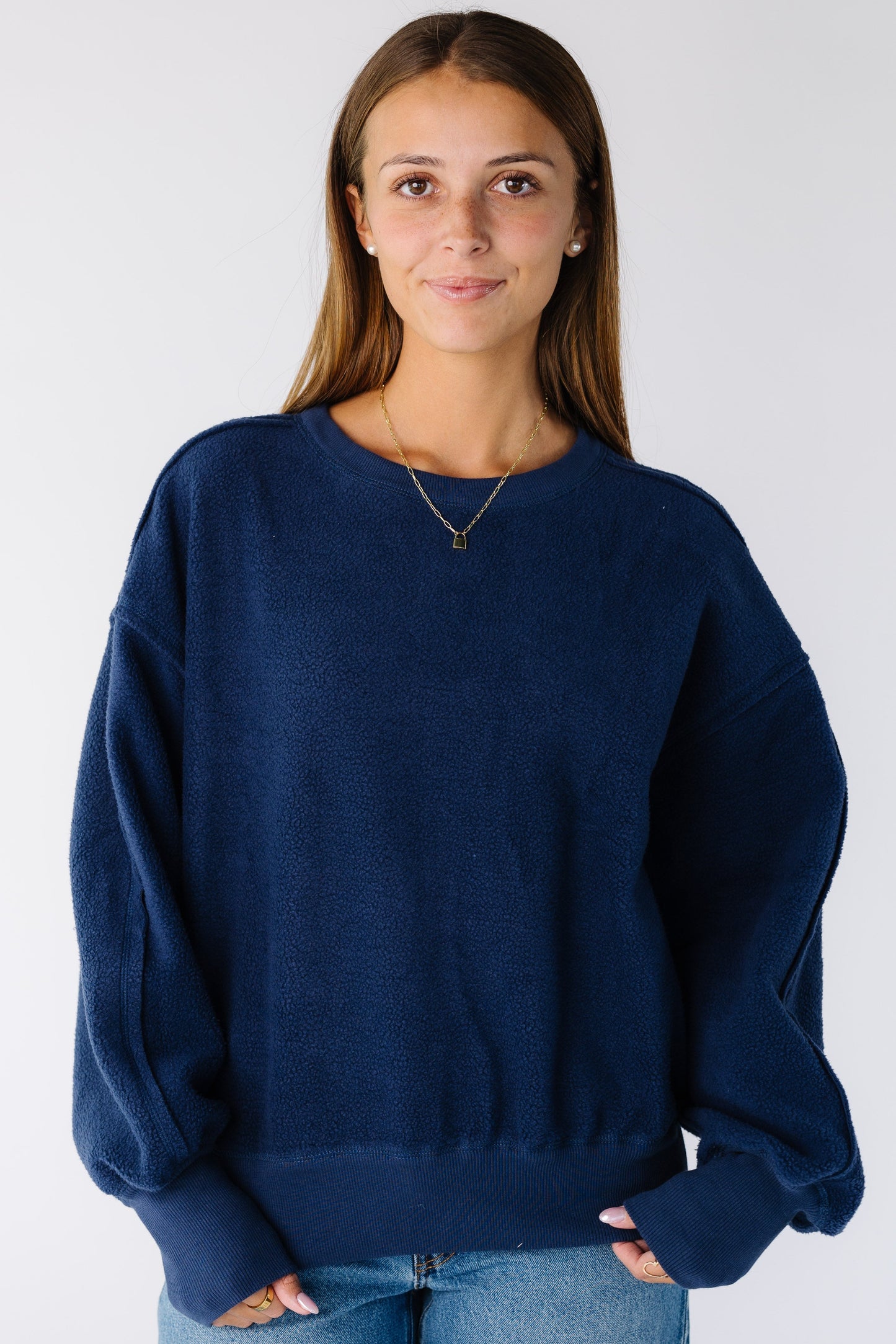 Woman wearing a modest navy sweatshirt-sweater with a crew neckline and long sleeves