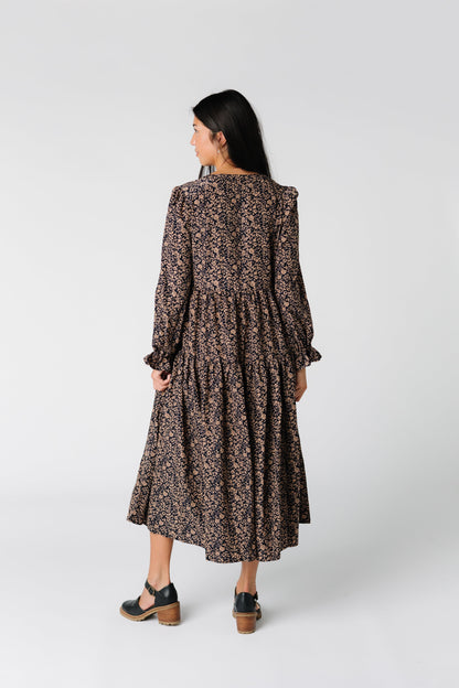 Back view of black print midi dress with long sleeves