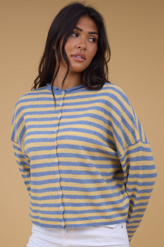 Young woman wearing a modest yellow & blue stripe, button down cardigan with drop shoulders and long sleeves.