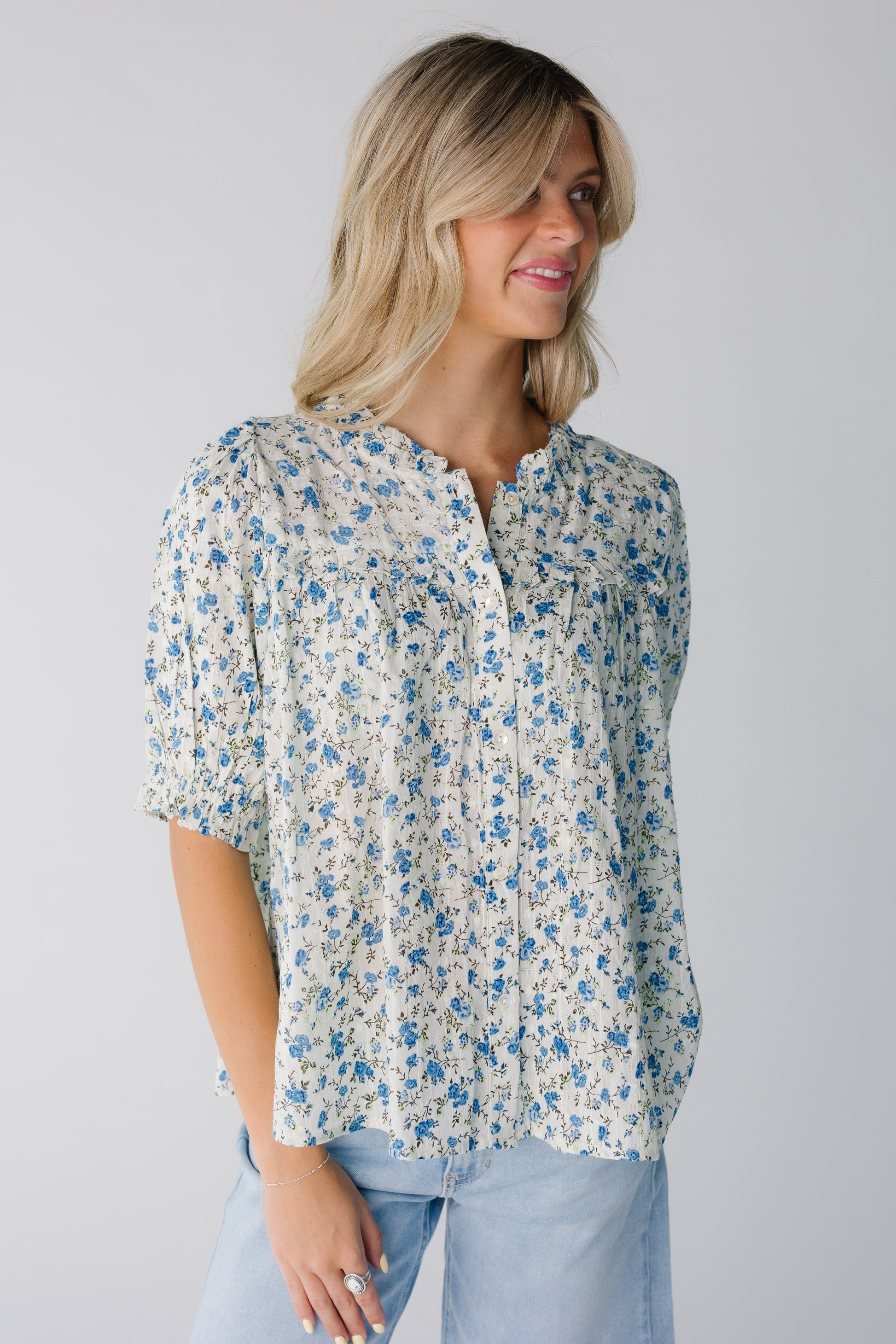 Modest blue floral button down top with round ruffled neckline and short puff sleeves