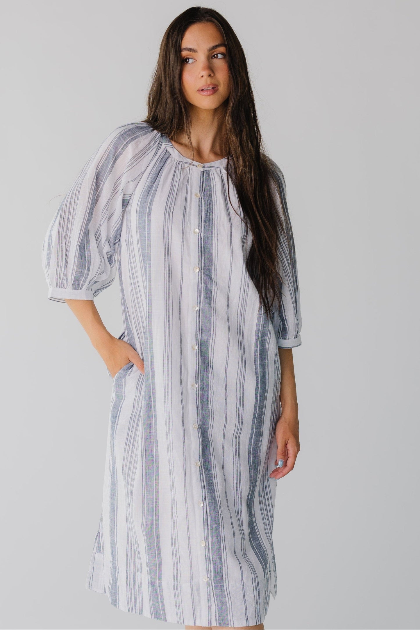 Modest blue and white stripe button down midi dress with three quarter length sleeves and round neck line.