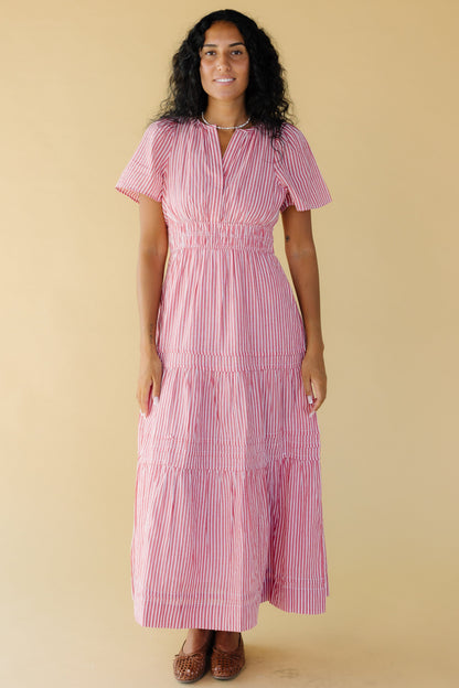 Young woman wearing a  modest red and white narrow stripe midi-maxi dress with a V-neckline and short sleeves.
