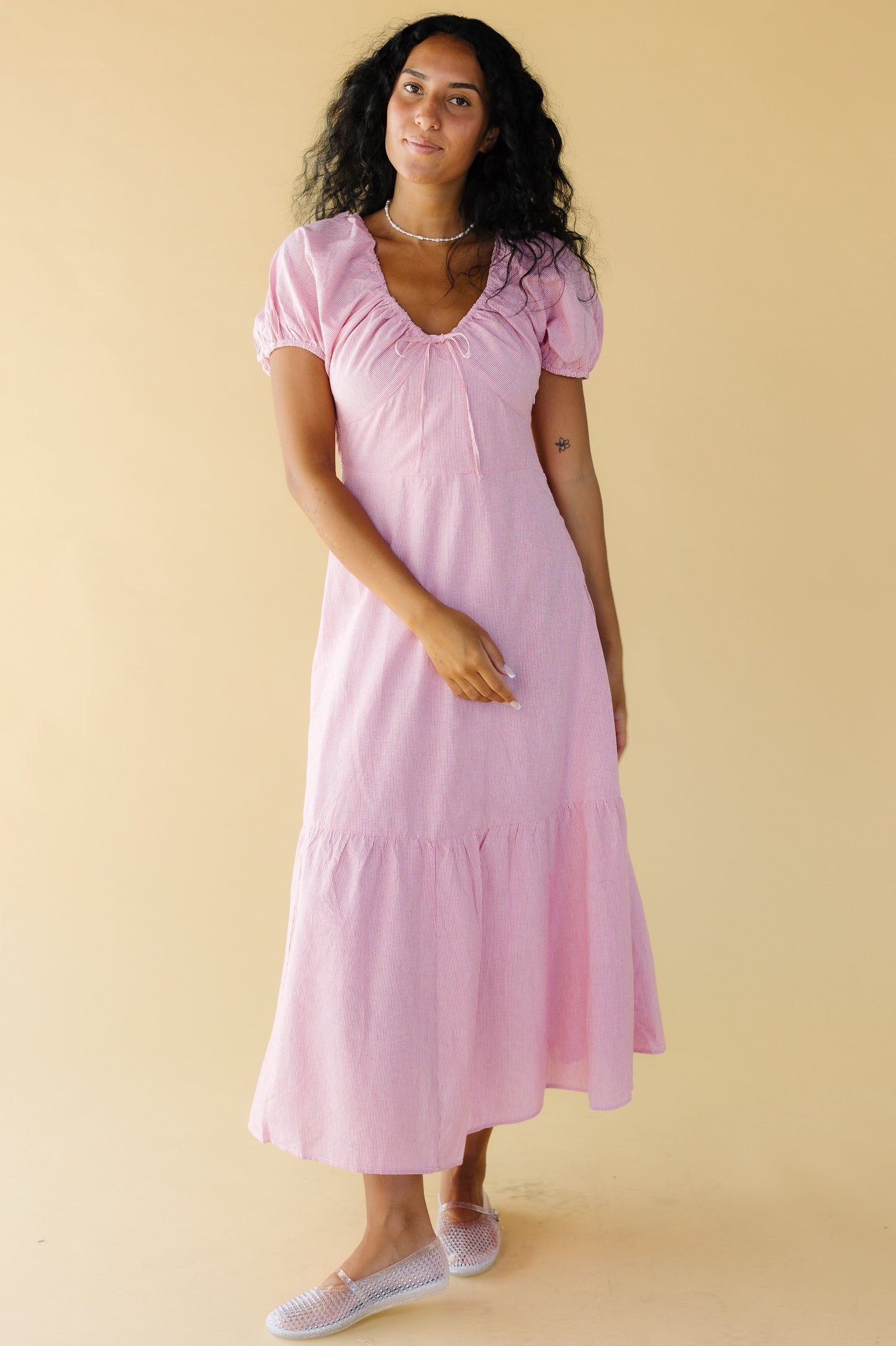 Young woman wearing a modest red & white stripe midi-maxi dress with puff sleeves and a drawstring and elastic scoop neckline and a wide bottom tier.