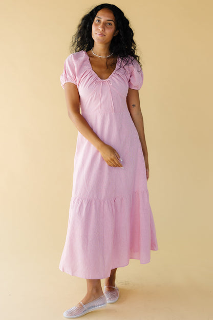 Young woman wearing a modest red & white stripe midi-maxi dress with puff sleeves and a drawstring and elastic scoop neckline and a wide bottom tier.