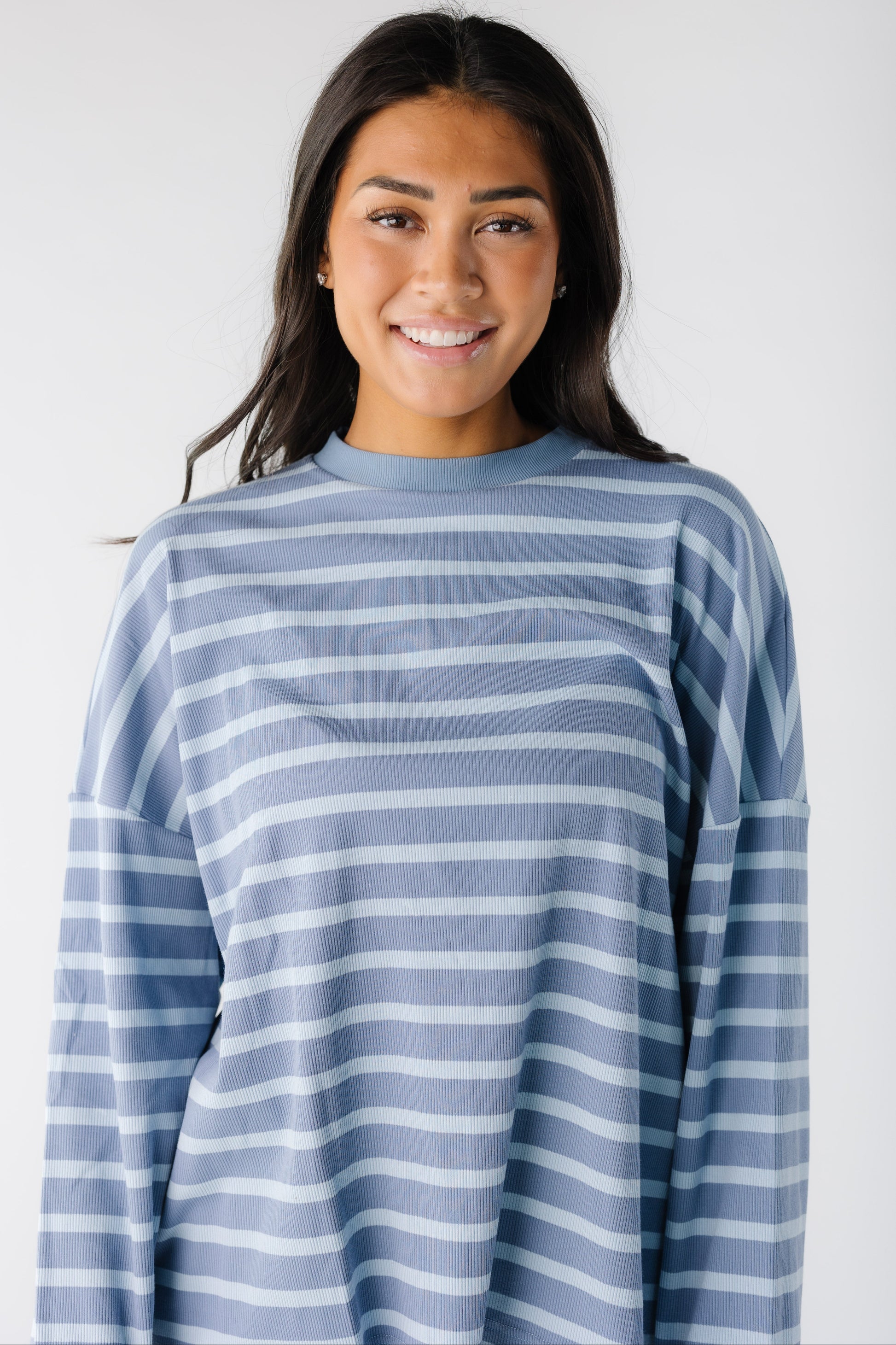 Close view of a woman wearing a light blue stripe lounge top.