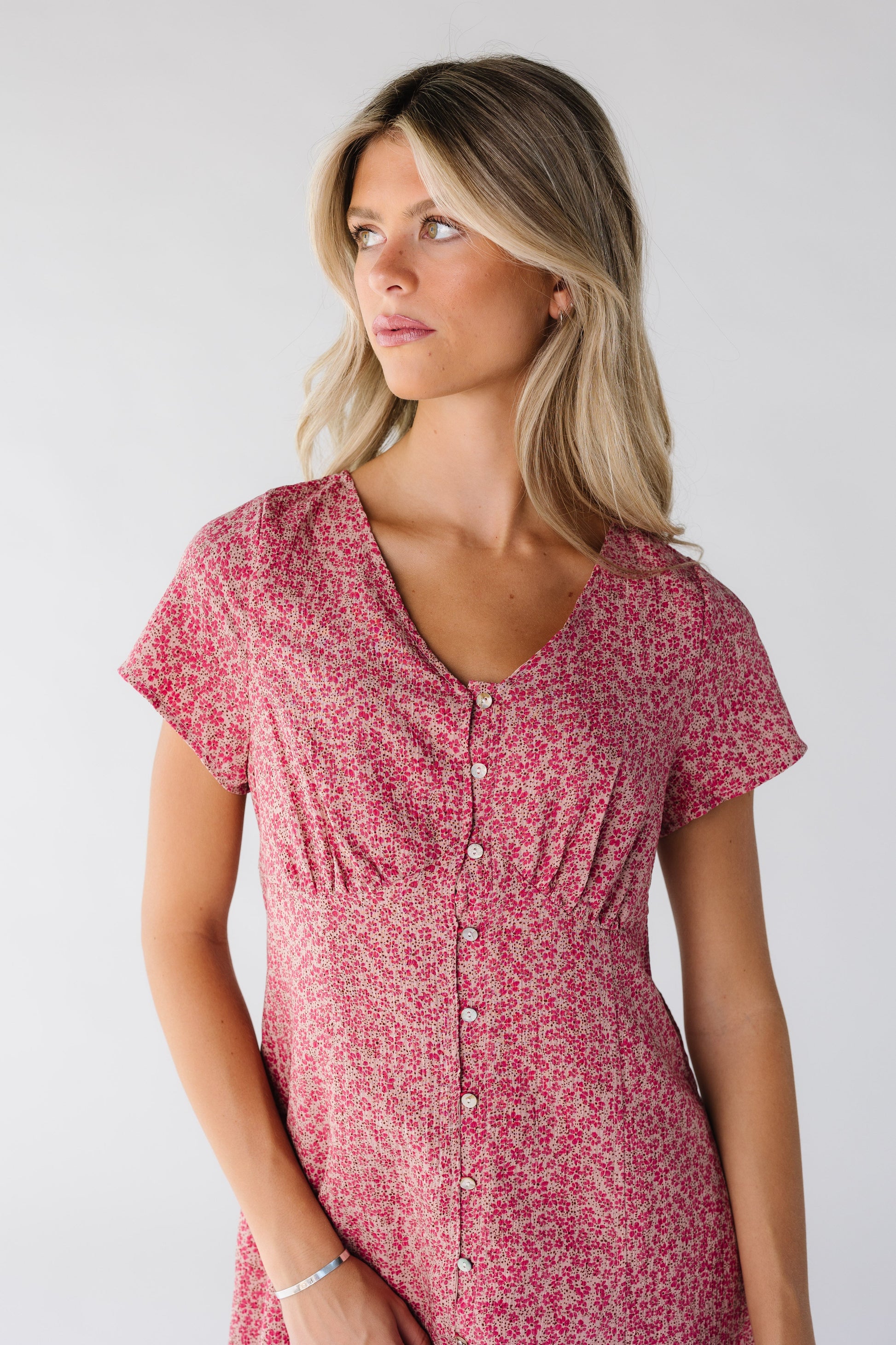 Modest women's pink floral dress with V-neckline and short sleeves