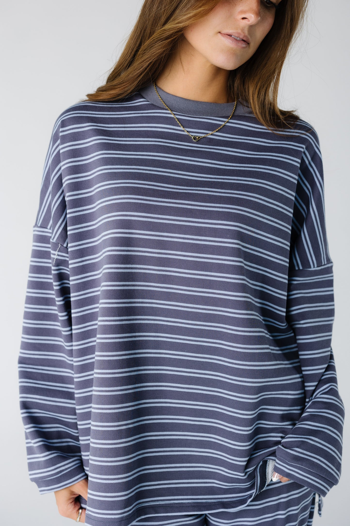 Women wearing a plum and blue stripe lounge set with a crew neckline and long sleeves