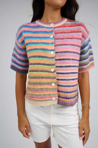 Woman wearing a button down cardigan with short sleeves.