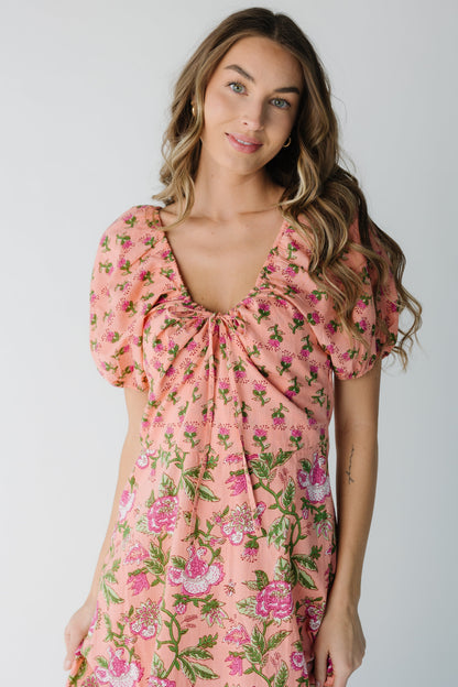 Close view of pink dress with scoop neckline and short puff sleeves