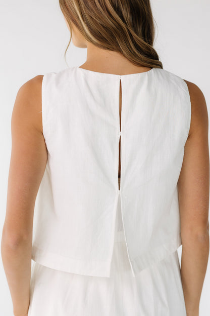 Close back view of a woman wearing a  1 piece dress with 3 hidden button closure.