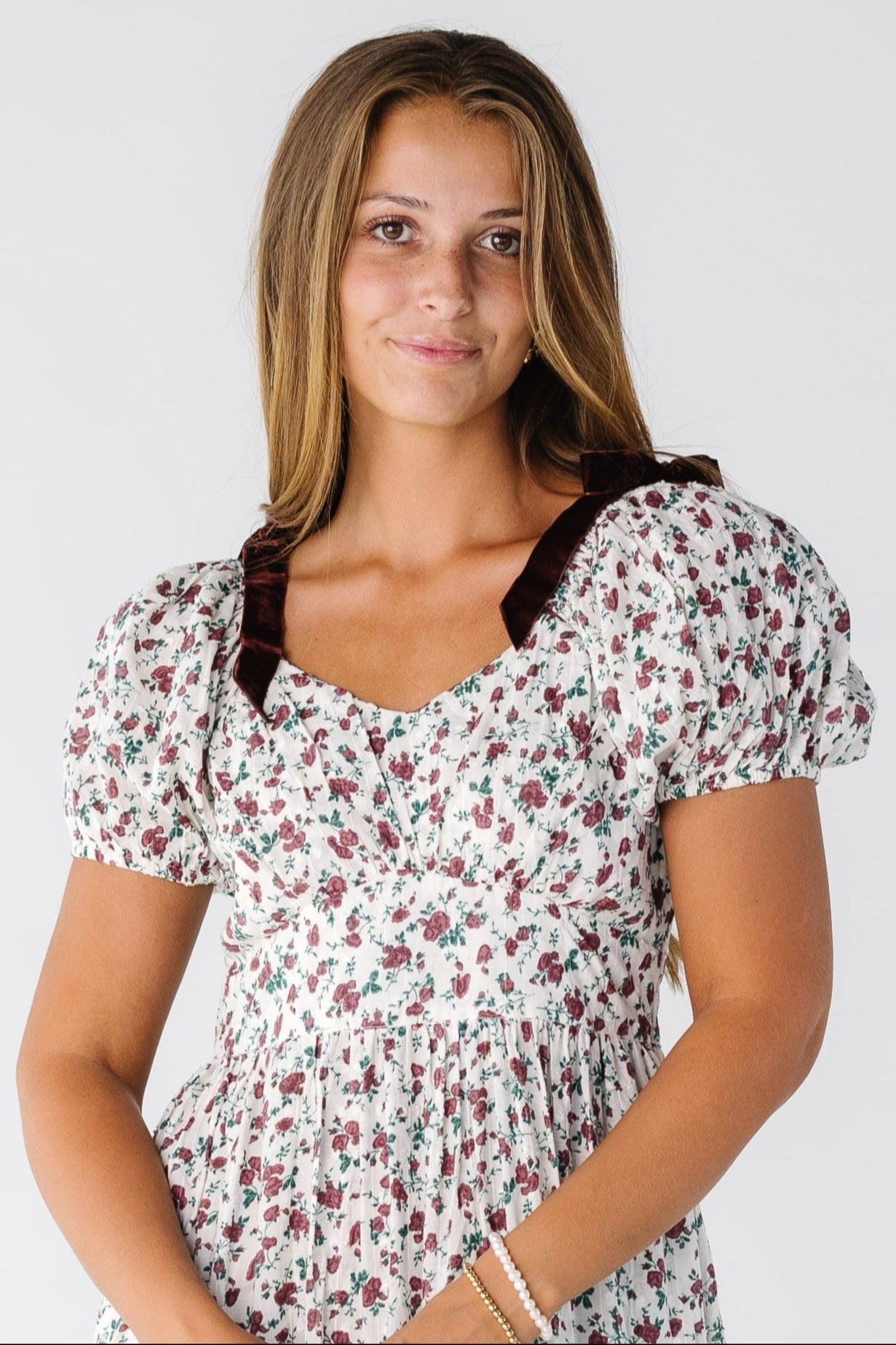 Citrus The Swiss Dobby Bow Dress for women and teens in  a white and burgundy floral dress with shoulder bows