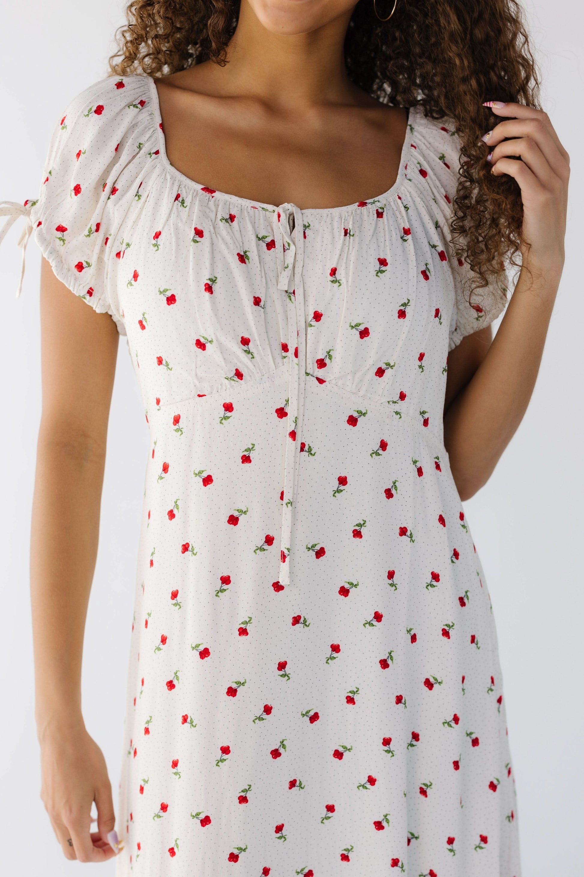 Closer view of a teen girl wearing a close fitting midi-maxi dress with short sleeves and a wide scoop neckline.
