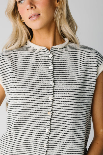 Close view of white with black stripe sweater vest