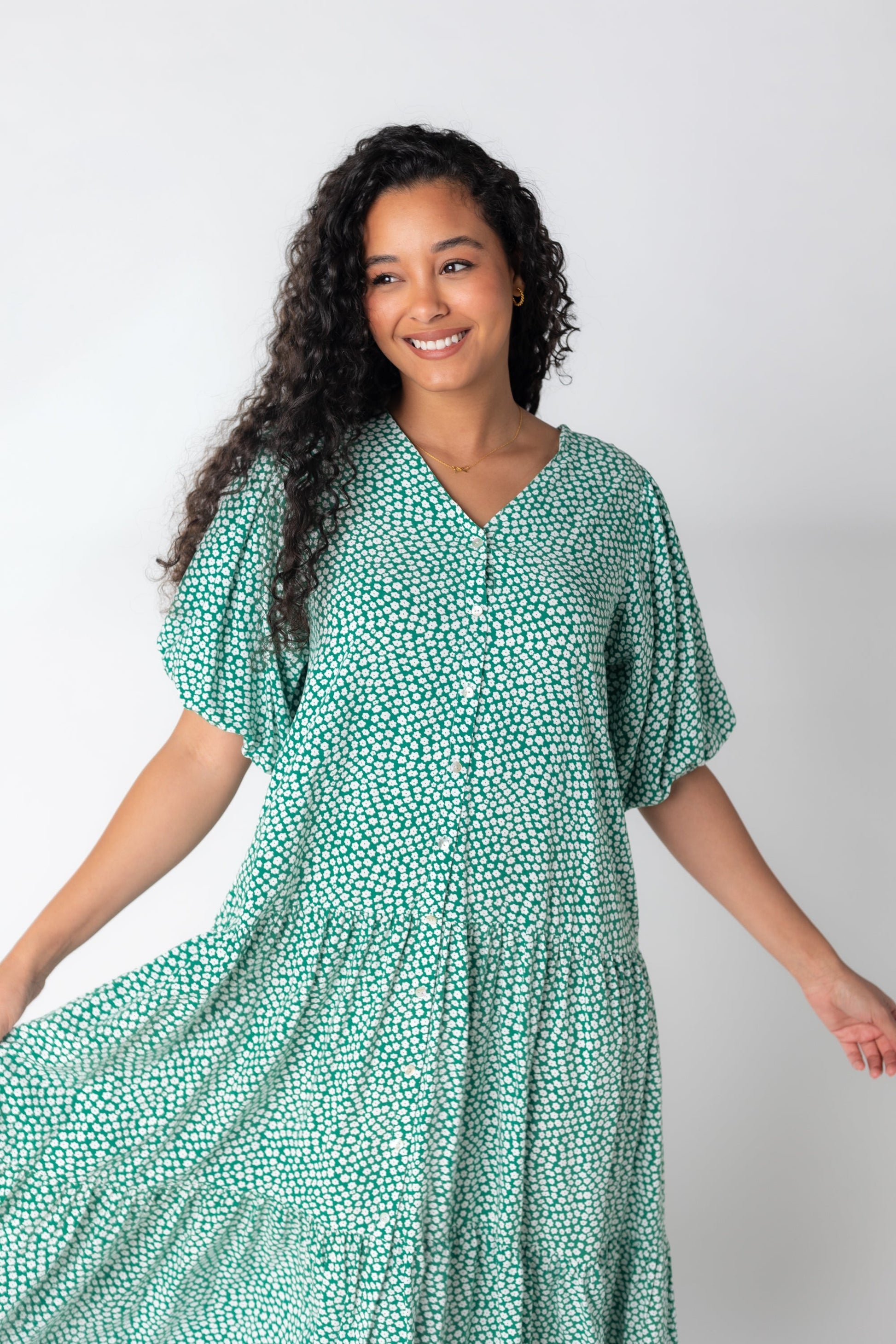 Modest button down dress with V-neckline and wide bottom tier