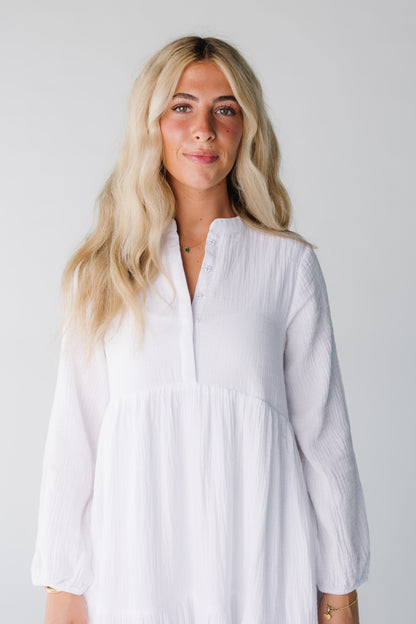 Close view of women's white crepe textured dress with long sleeves