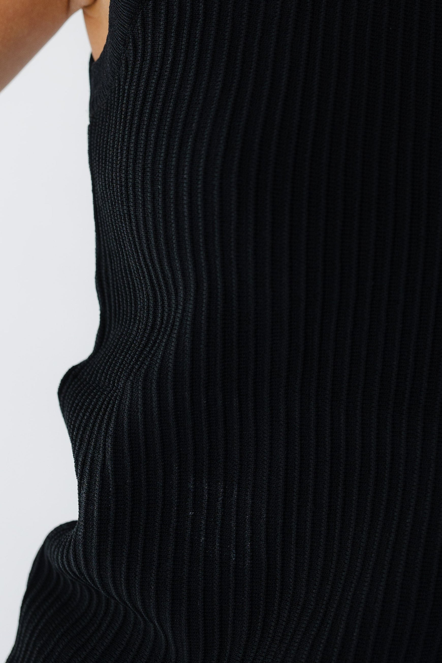 Close view of the ridge stripe texture on a black tank top.
