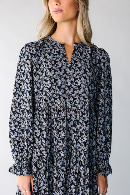 Close view of a woman wearing a blue floral dress with long sleeves