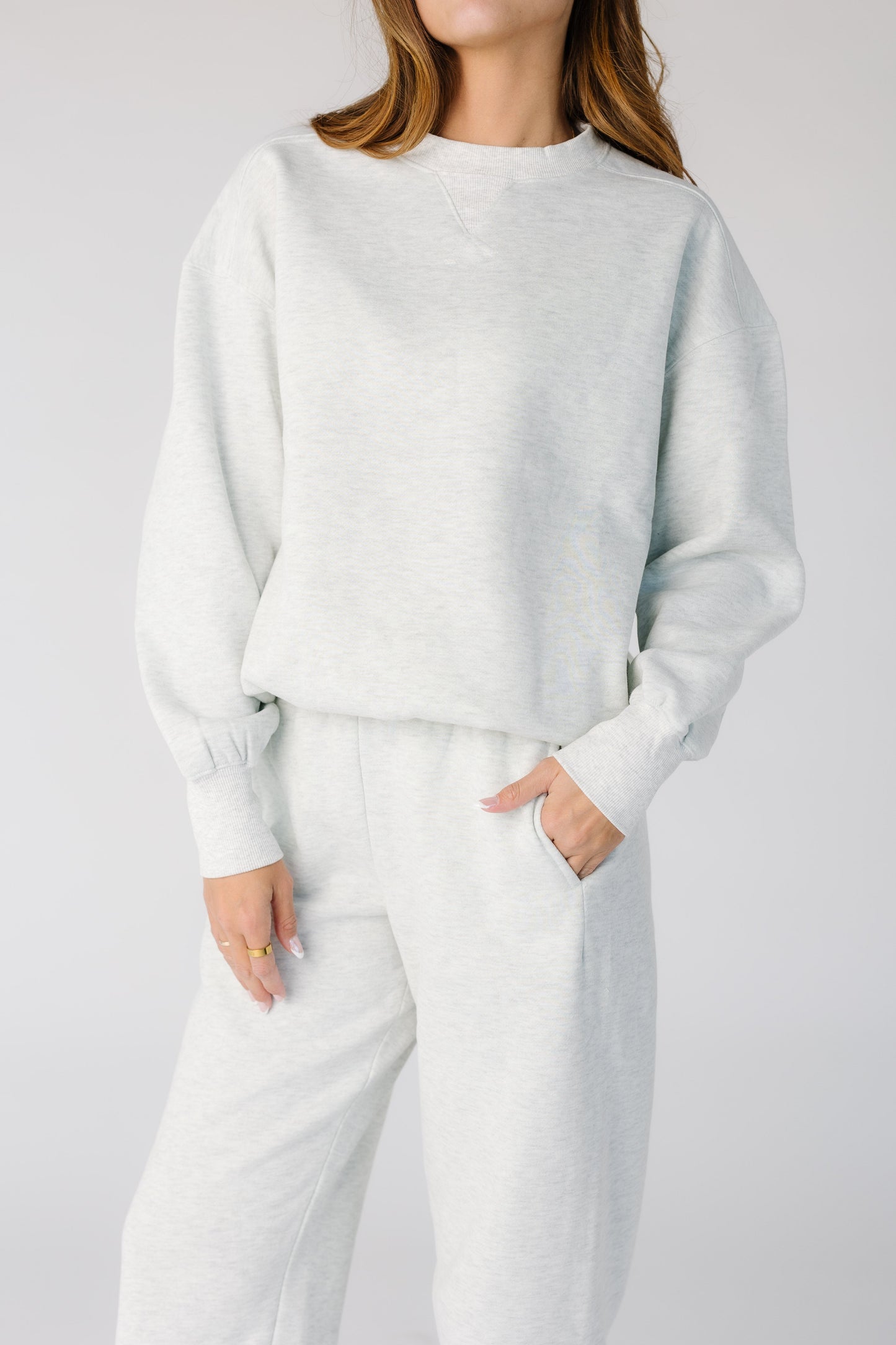 Close view of a woman wearing a light grey sweat top