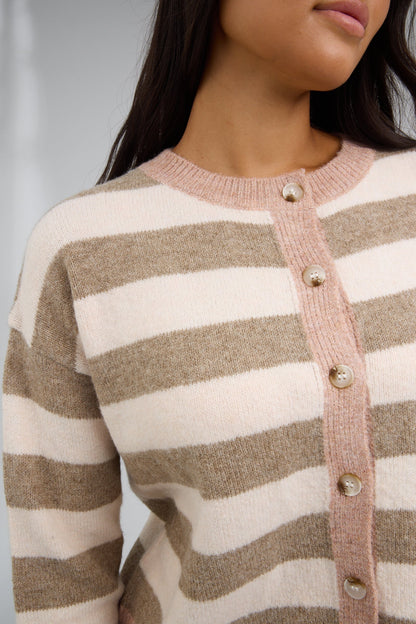 Close view of a young woman wearing a mocha brown & taupe stripe cardigan with a beige button down placket.