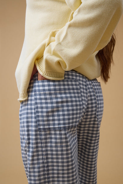 Close view of a woman wearing navy  & white plaid check for women and teen girls.