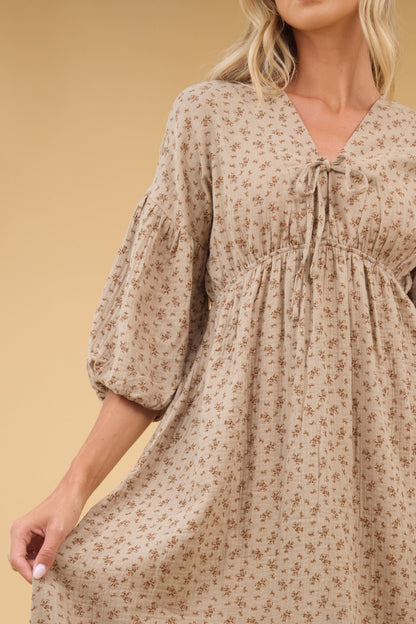 Close view of a young woman wearing an empire waist V-neckline and half length sleeves.