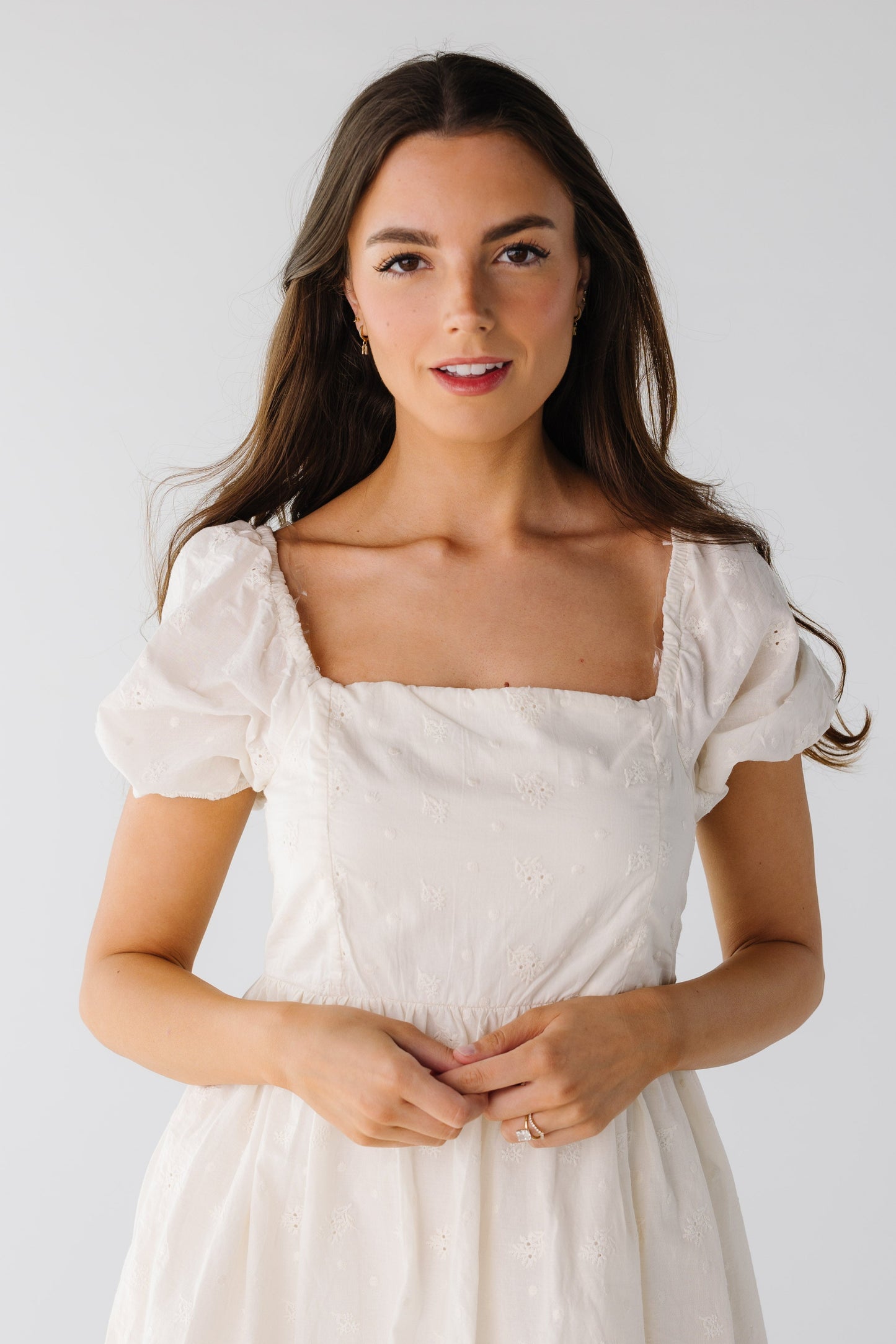 Close view of light eyelet square neck dress