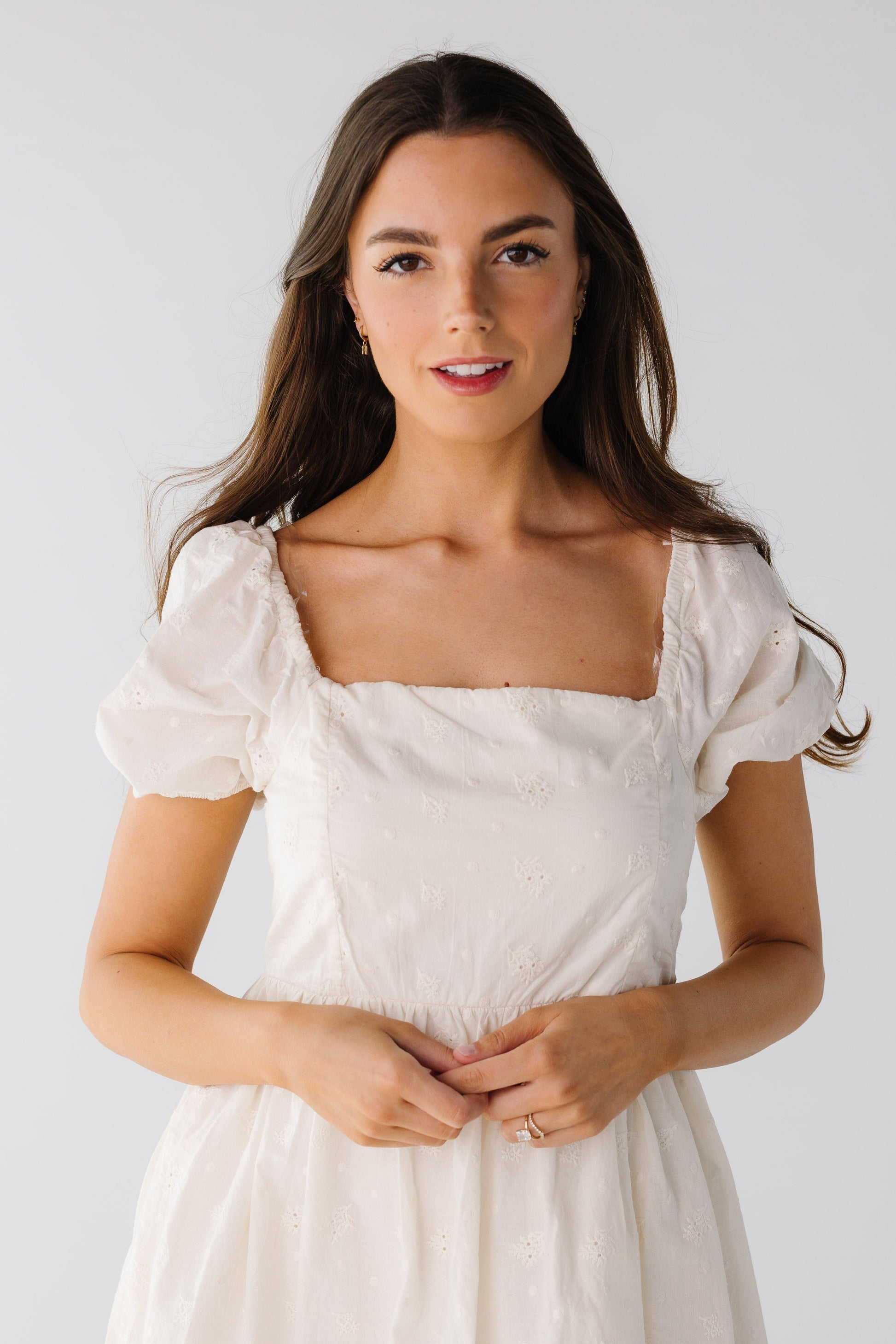 Close view of light eyelet square neck dress