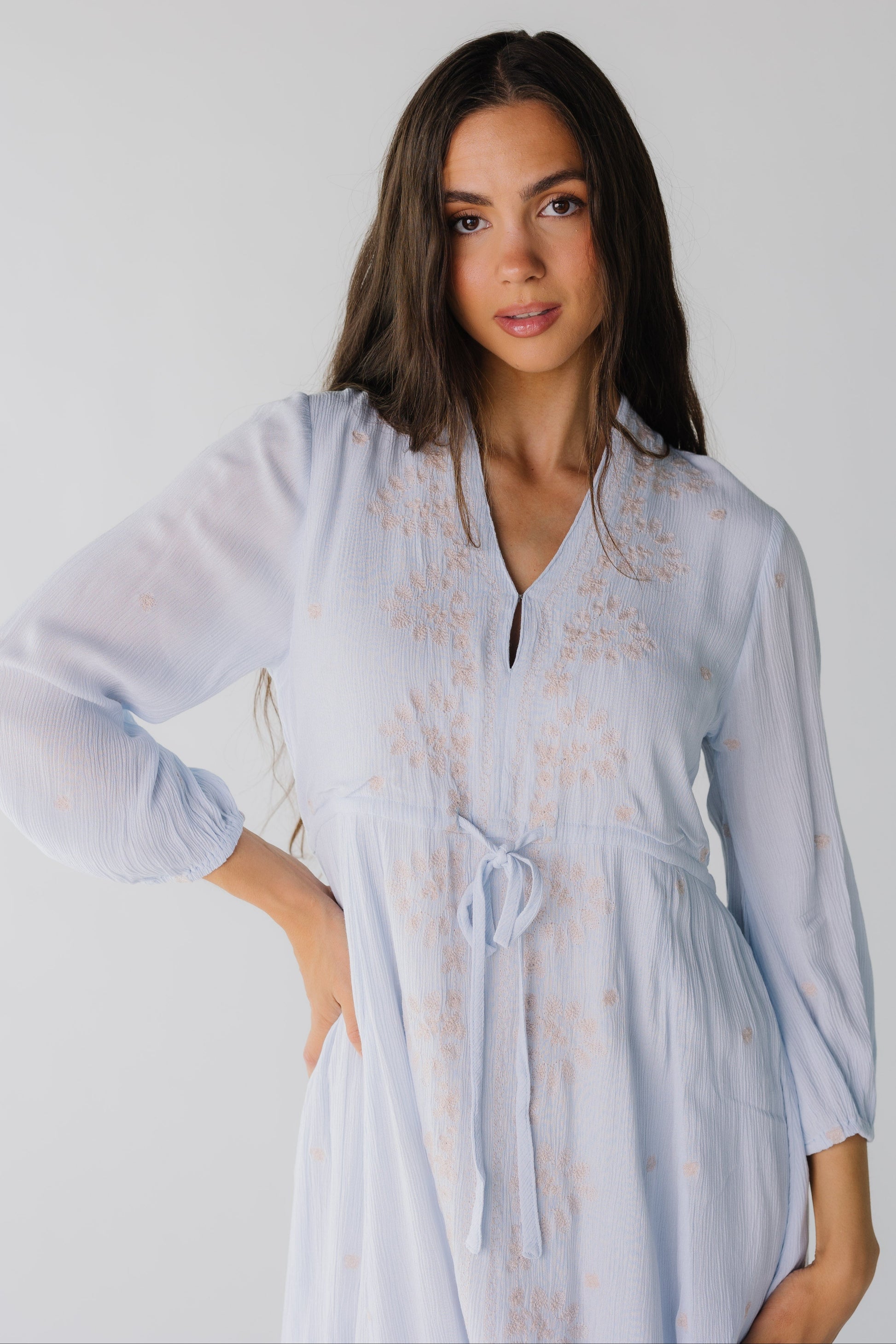 Close view of light blue dress with front embroidered with drawstring waist