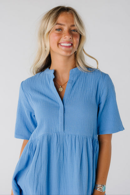 Woman wearing blue dress with V-neckline and short sleeves