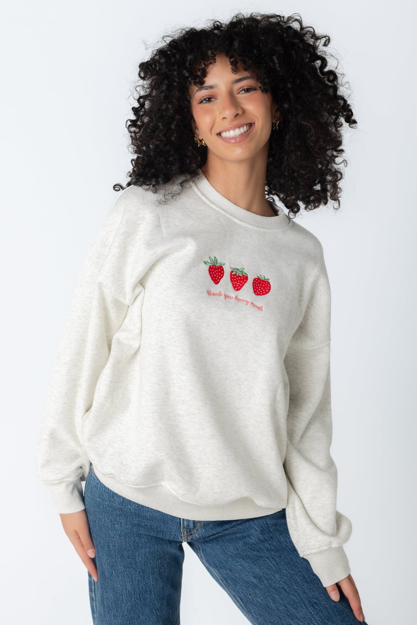 White crewneck sweatshirt with embroidered strawberry graphic