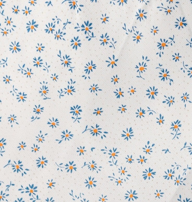 White with blue floral print fabric swatch.