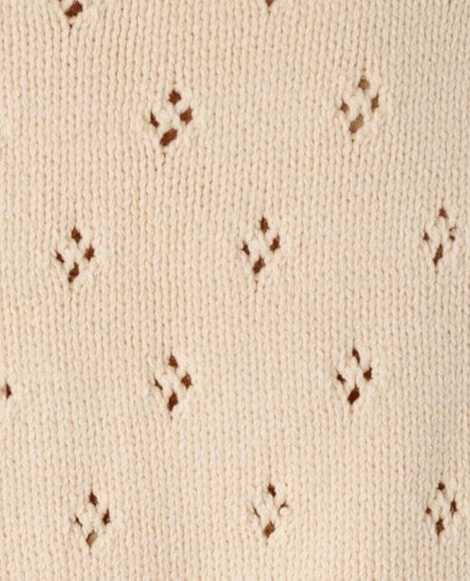 Cream eyelet knit fabric swatch.