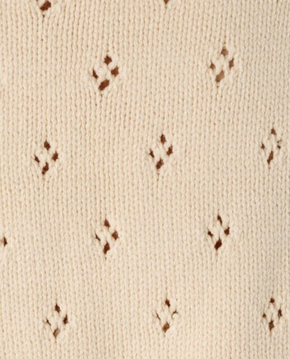 Cream eyelet knit fabric swatch.