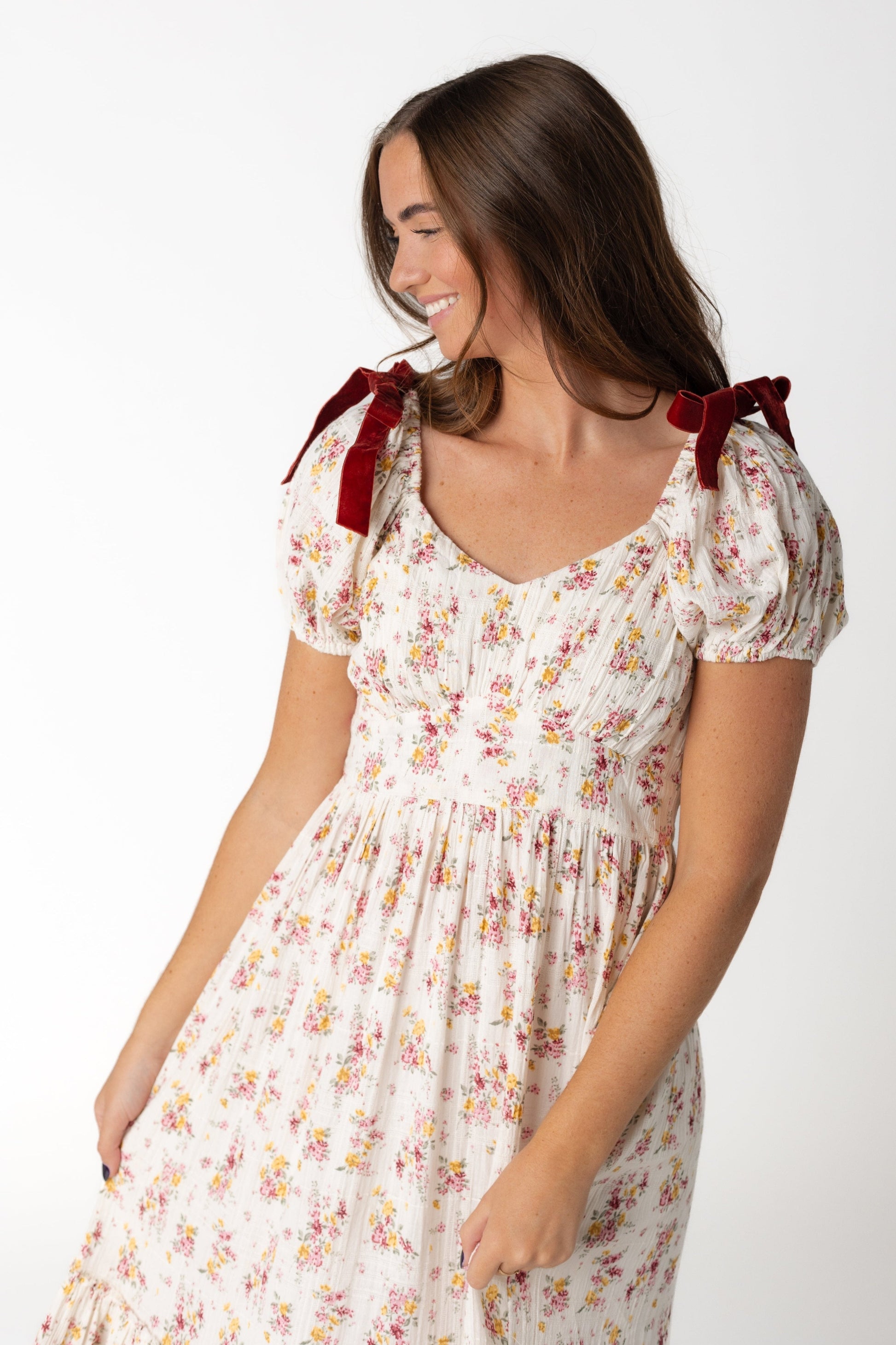 Close view of cream midi with sweetheart neckline and side waistband with short puff sleeves