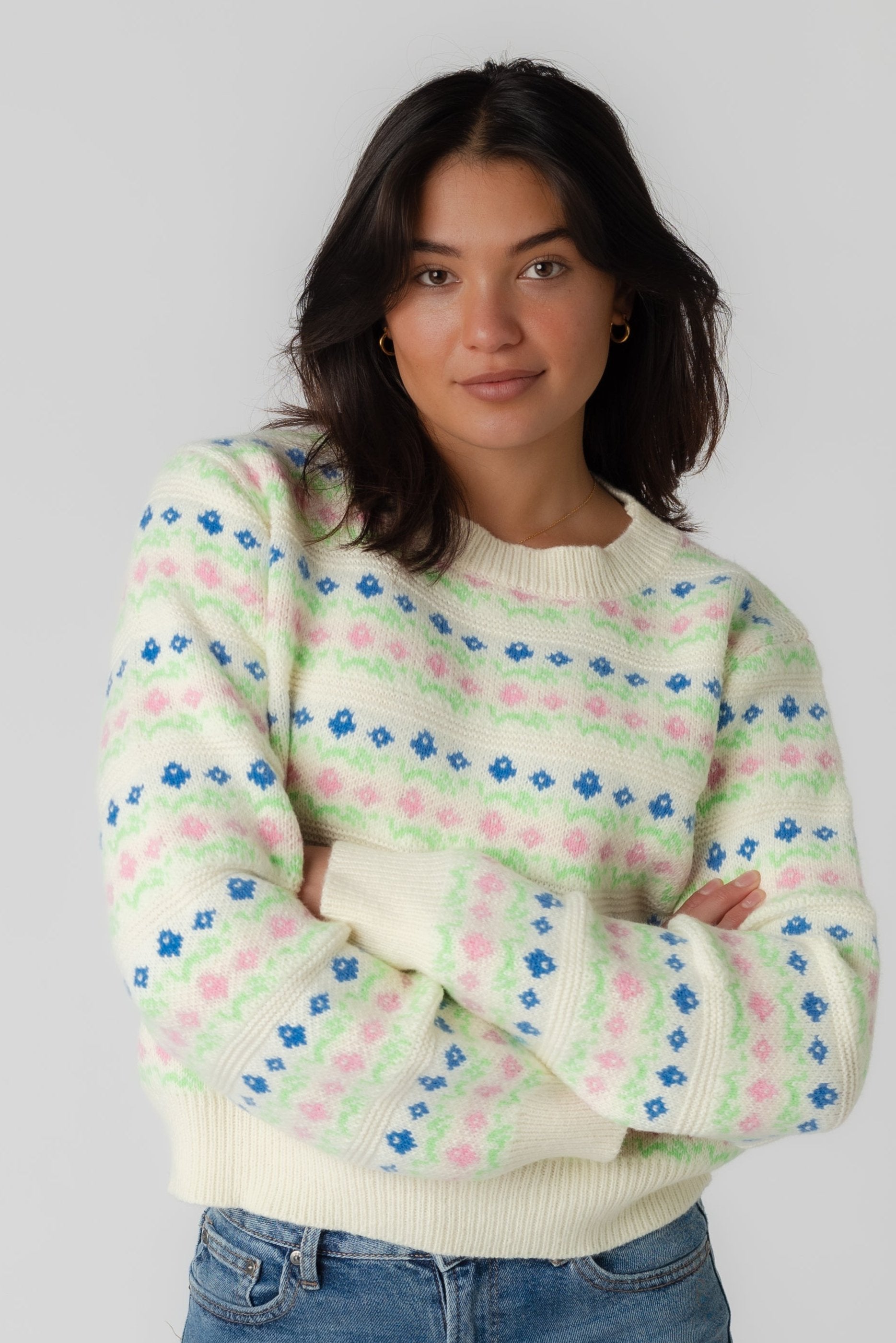 Modest patterned sweater in blue pink and green with cream background