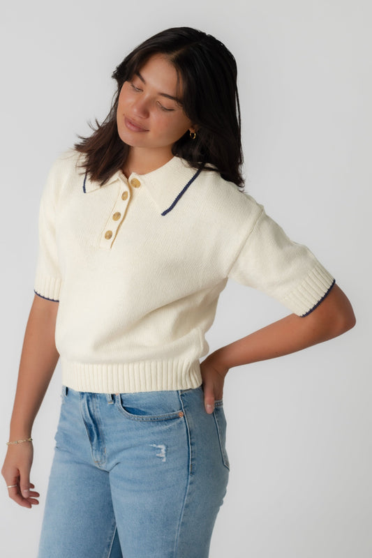 Cream pullover sweater with short sleeves and short front button placket