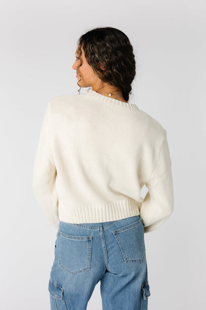 Back view of cream waist length sweater