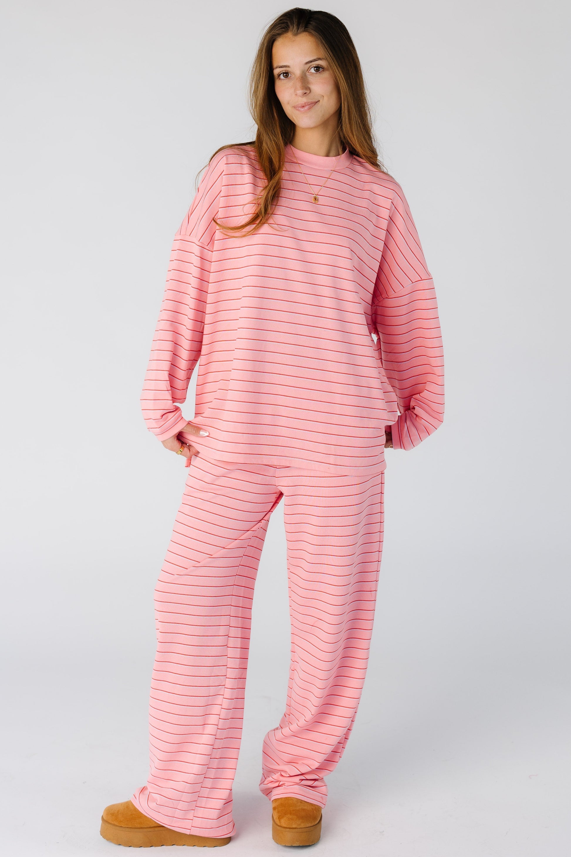 Woman wearing a modest pink lounge set in pink with a crew neckline, long sleeves and long pants