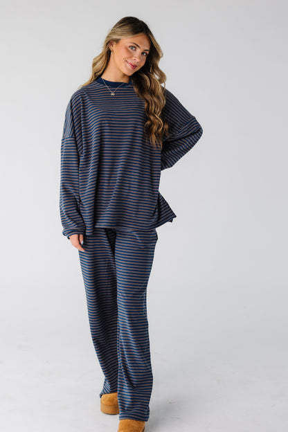 Woman wearing a modest dark blue lounge set with long sleeves and long pants.