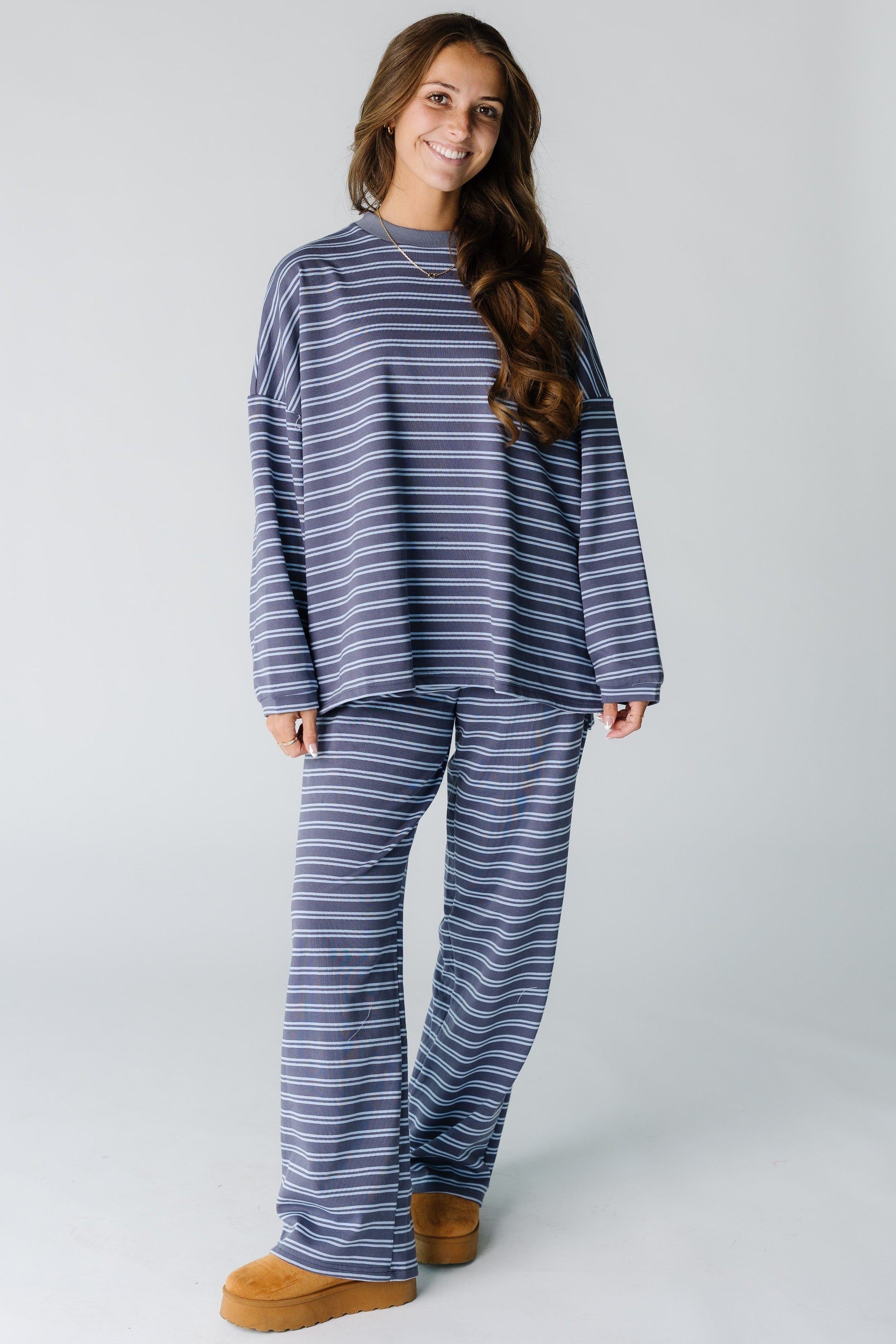 Woman wearing a modest  plum and blue stripe lounge set with a crew neckline and long sleeves