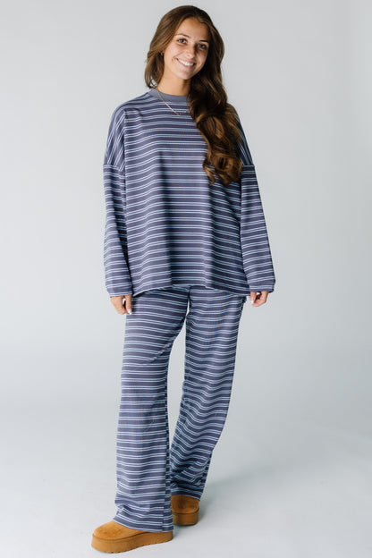 Woman wearing a modest  plum and blue stripe lounge set with a crew neckline and long sleeves